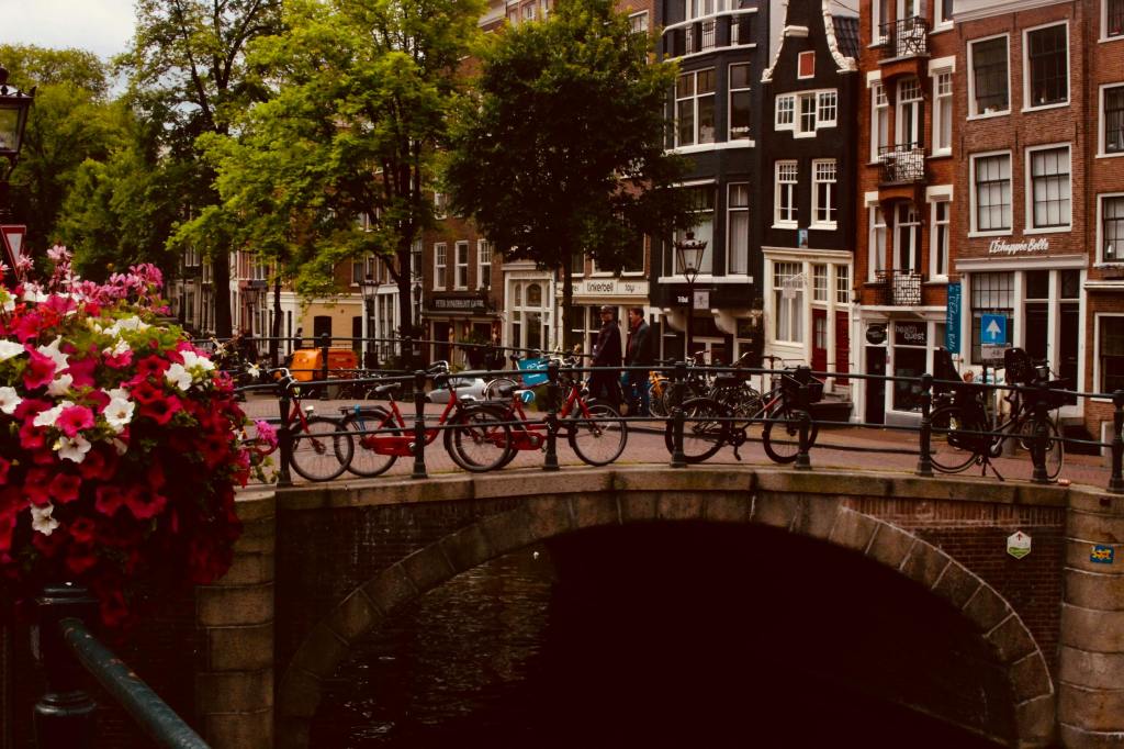 Bicycles leaning against railing in Amsterdam.