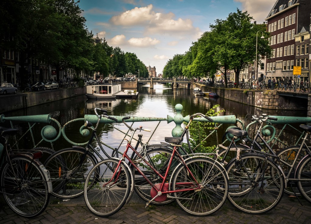Bicycles parked along a cobblestone street in Amsterdam, showcasing the city's cycling culture.