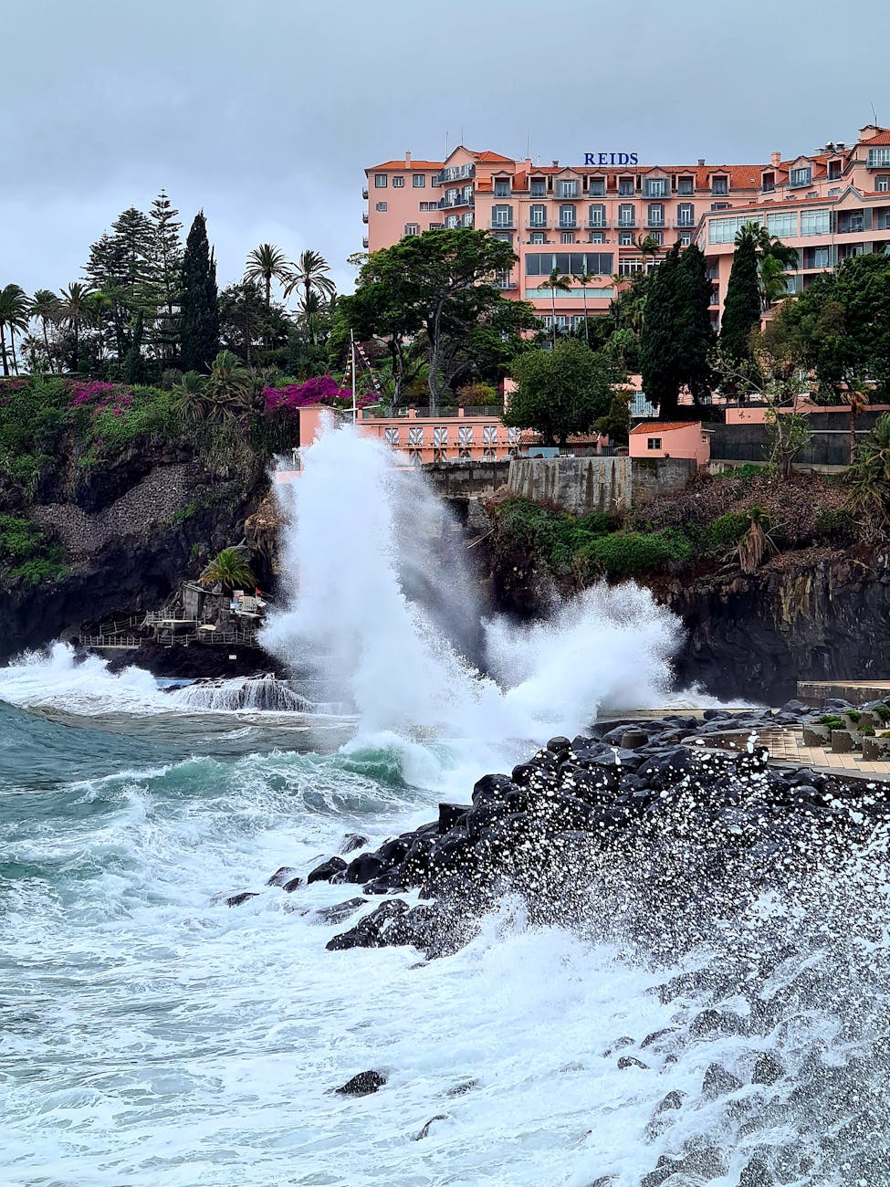 wave crushing on sea shore in funchal in madeira